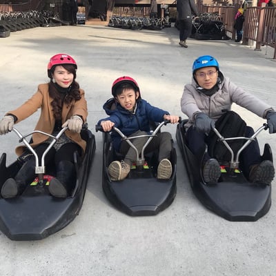 A mother and father go Luging with their son at Skyline Luge Tongyeong.