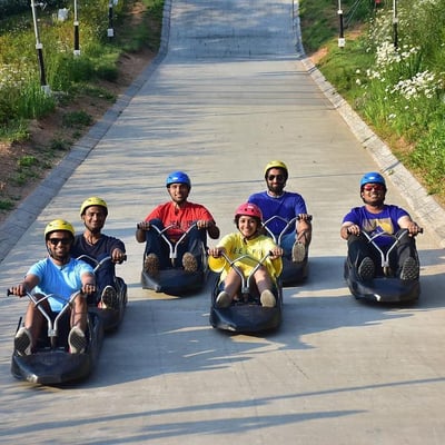 A large group of friends line up for a photo on the Luge tracks.
