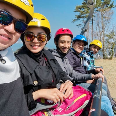 A group of people ride the Skyride together.