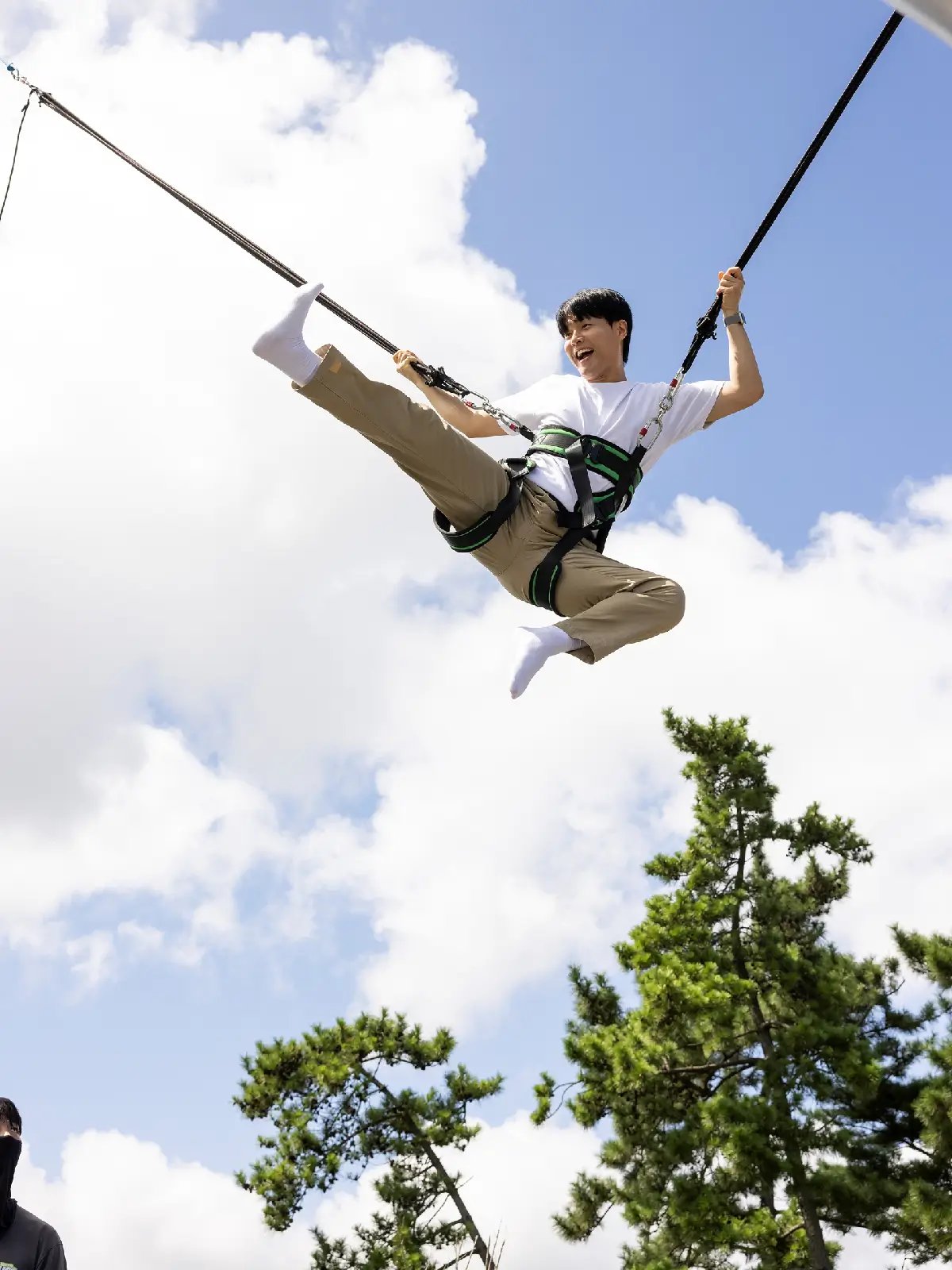 Young rider jumping high on the Euro Bungy at Skyline Luge Tongyeong.