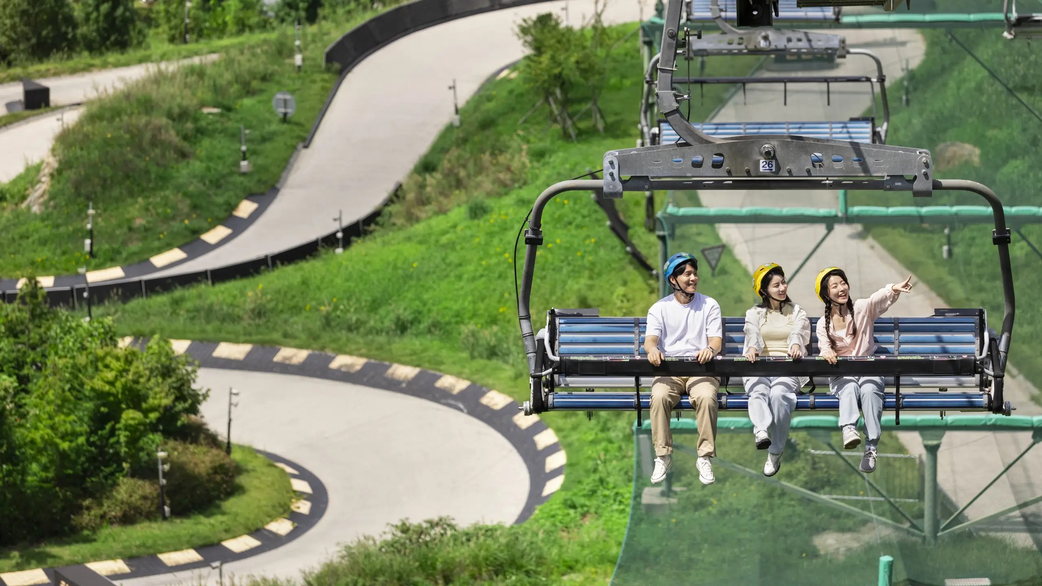 Riders on the Skyride passing above the Skyline Luge Tongyeong track.